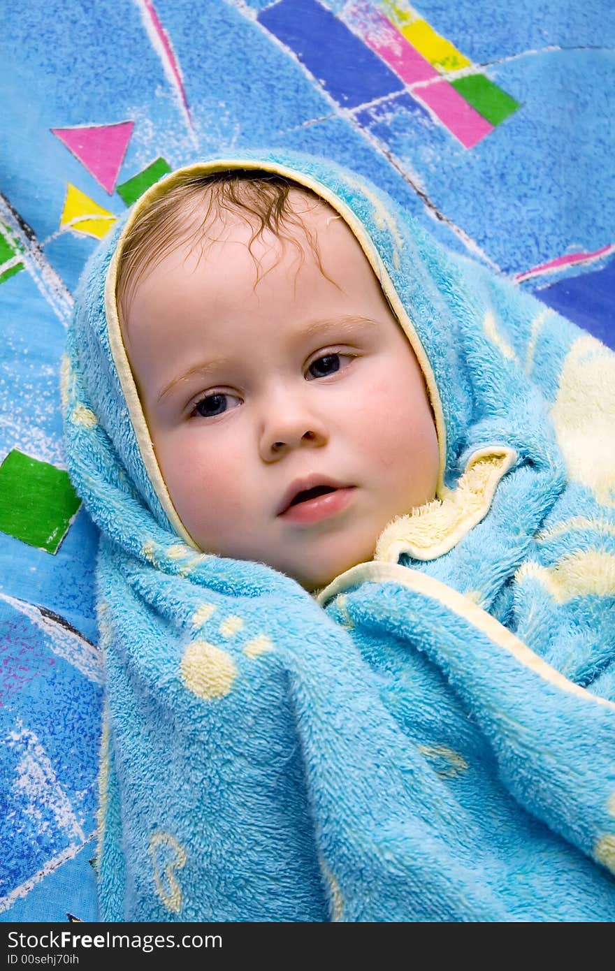 Baby after bath under towel