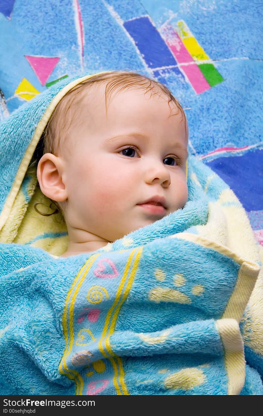 Baby after bath under towel