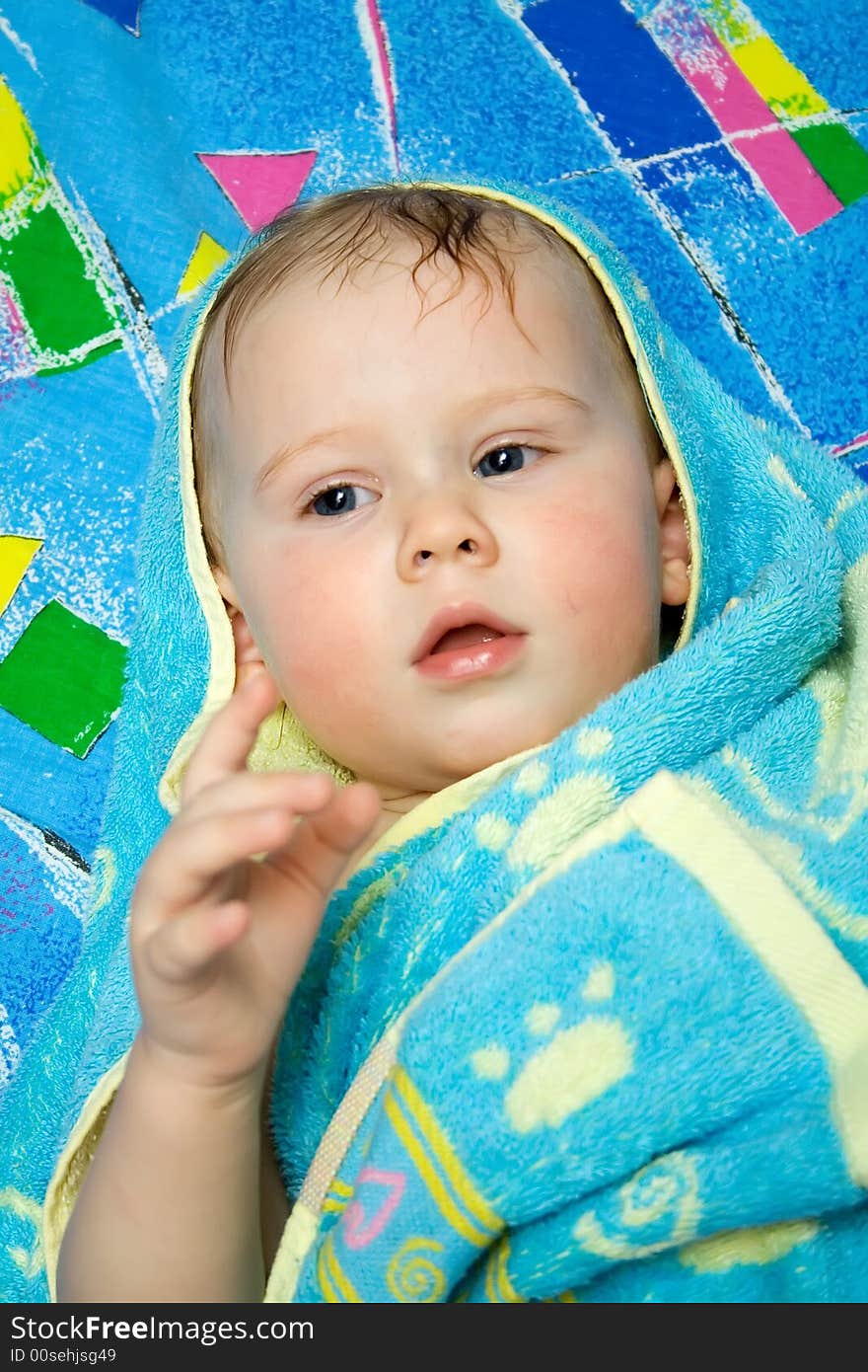 Baby after bath under towel