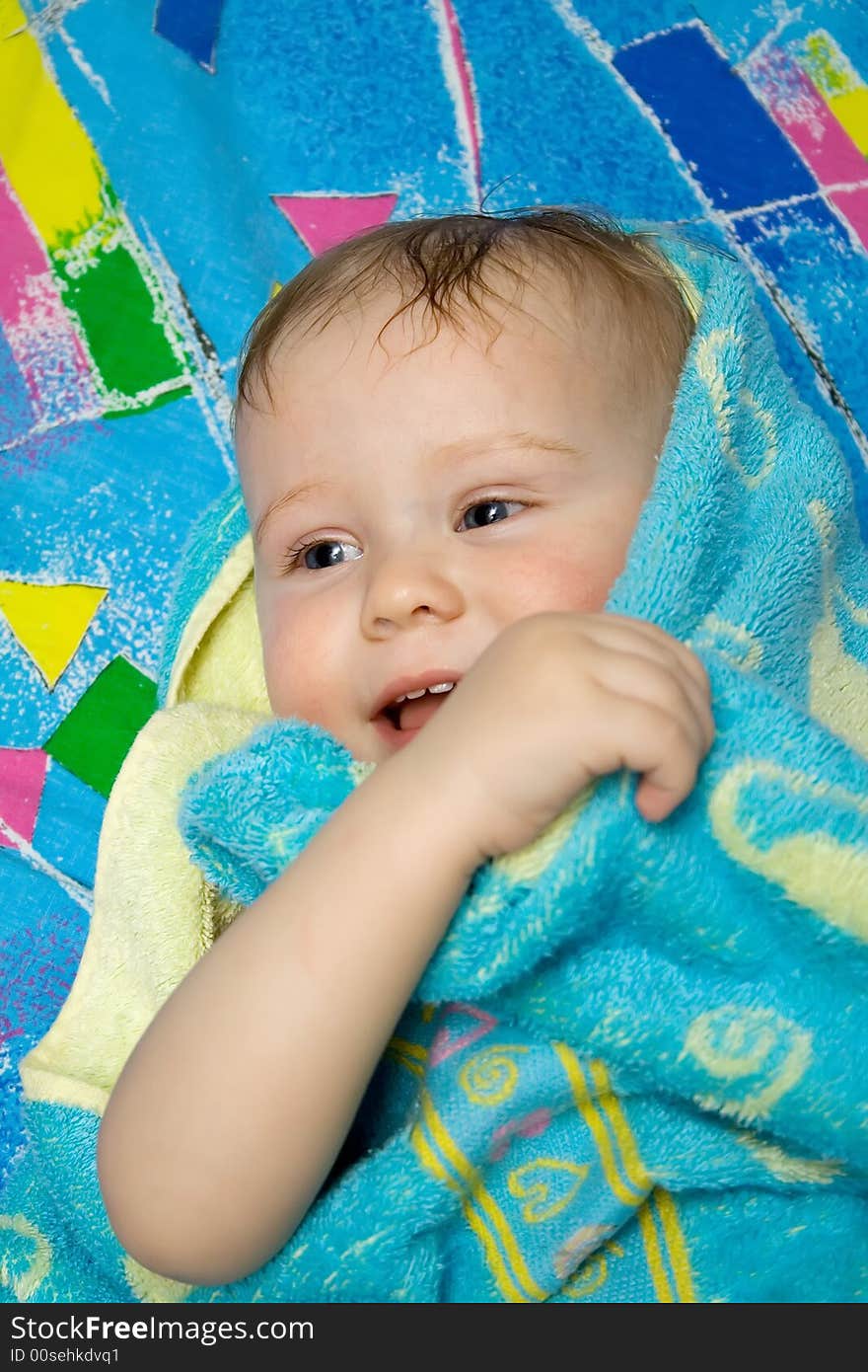 Baby after the bath under towel