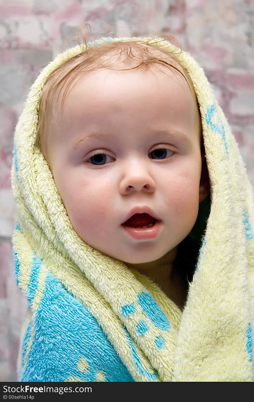 Baby after the bath under towel