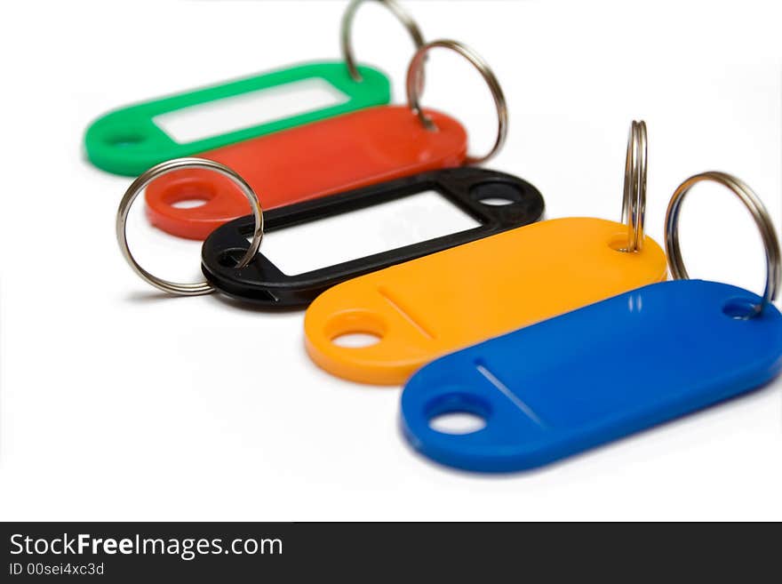 Multicolored plastic trinkets on white background