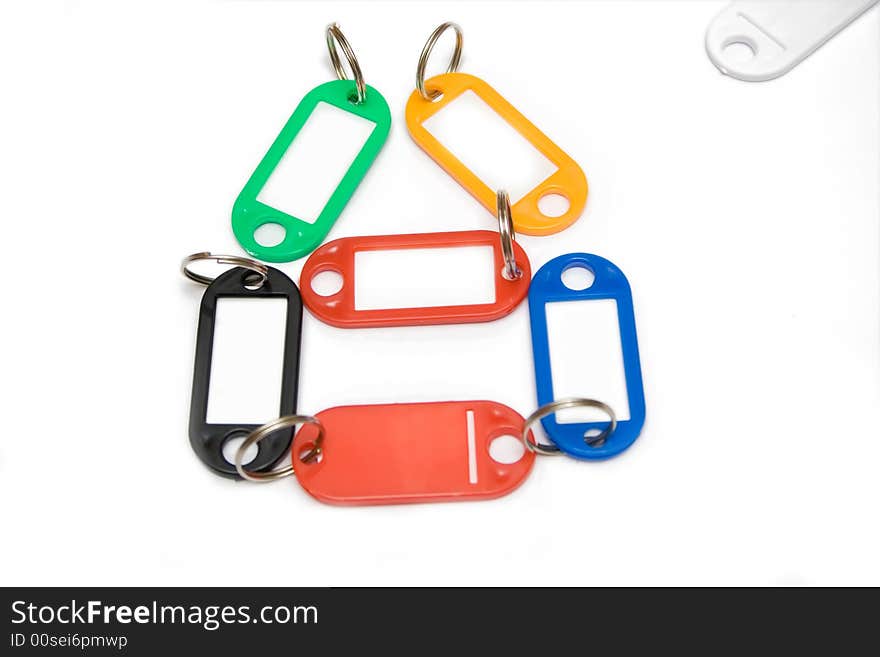 Multicolored plastic trinkets on a white background