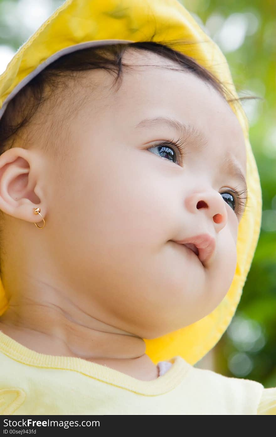 Close up photo of beautiful child wearing yellow hat. Close up photo of beautiful child wearing yellow hat