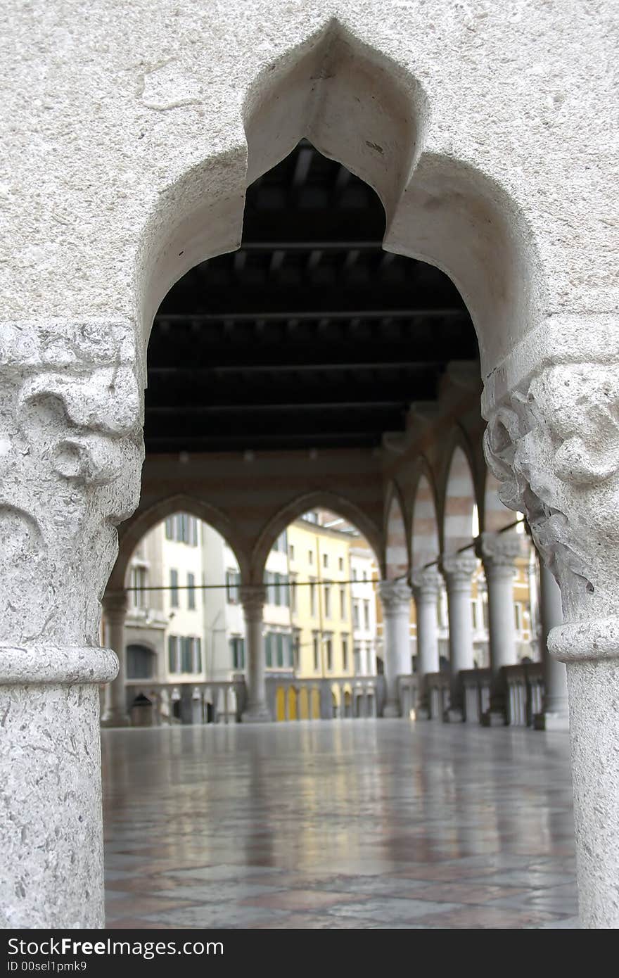 Architectural view of an Orient-style balustrade opening a view to a marble floor and covered terrace with pillars and colorful buildings background. Architectural view of an Orient-style balustrade opening a view to a marble floor and covered terrace with pillars and colorful buildings background