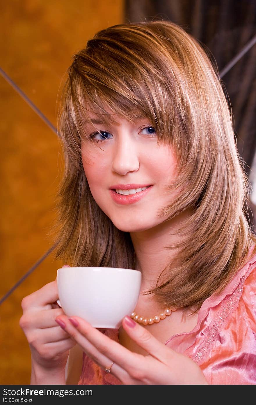 Smiley young woman with cup in hands