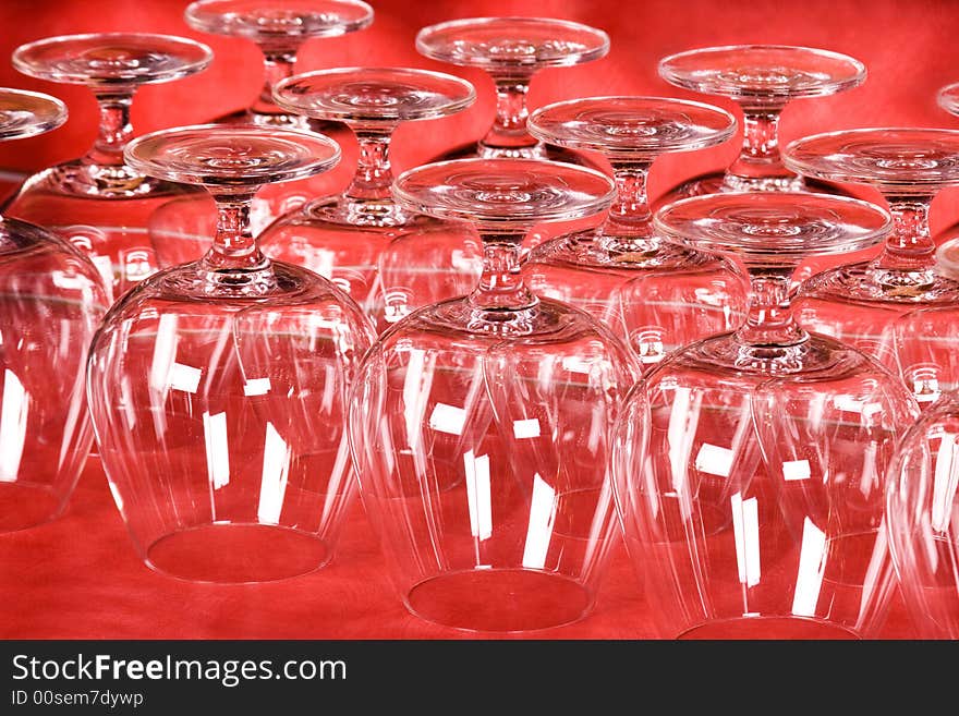 Empty wine glasses on red background