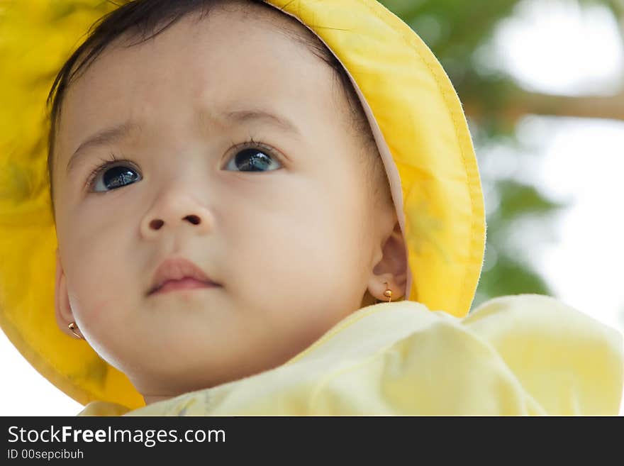 Close up photo of beautiful child wearing yellow hat. Close up photo of beautiful child wearing yellow hat