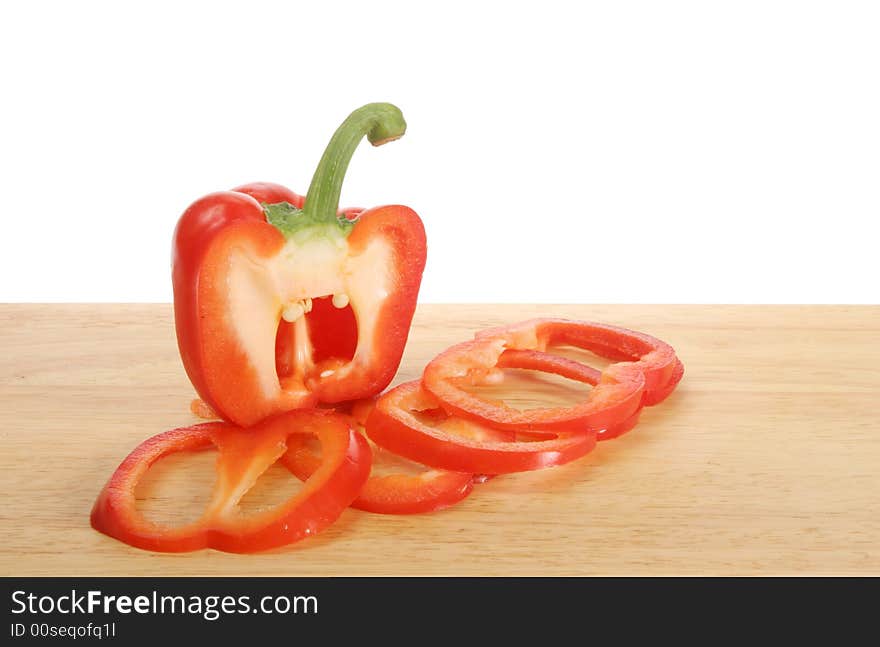 Sliced red pepper on a wooden board