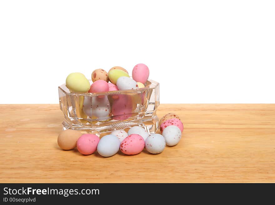 Mini Easter Eggs in a glass bowl on a wooden board