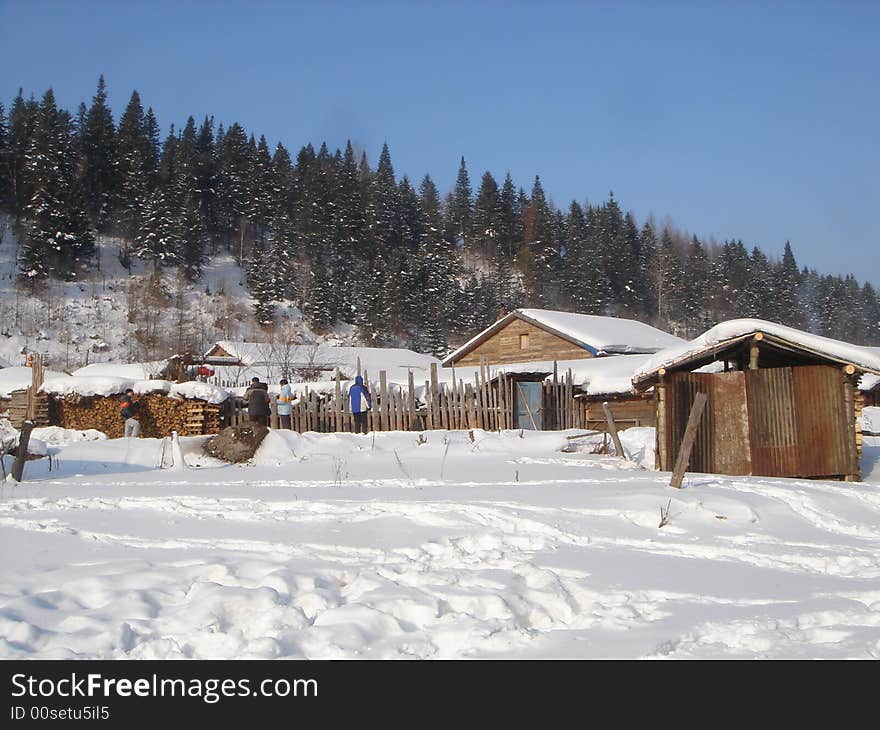 Wood cabins in snow mountain in northeastern china.