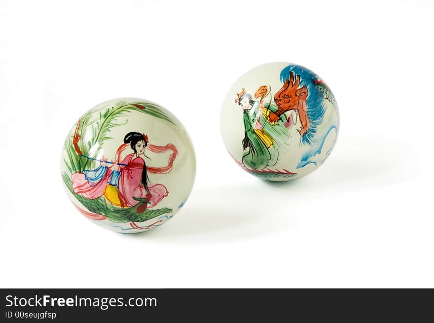 Two oriental balls with drawings on a white background