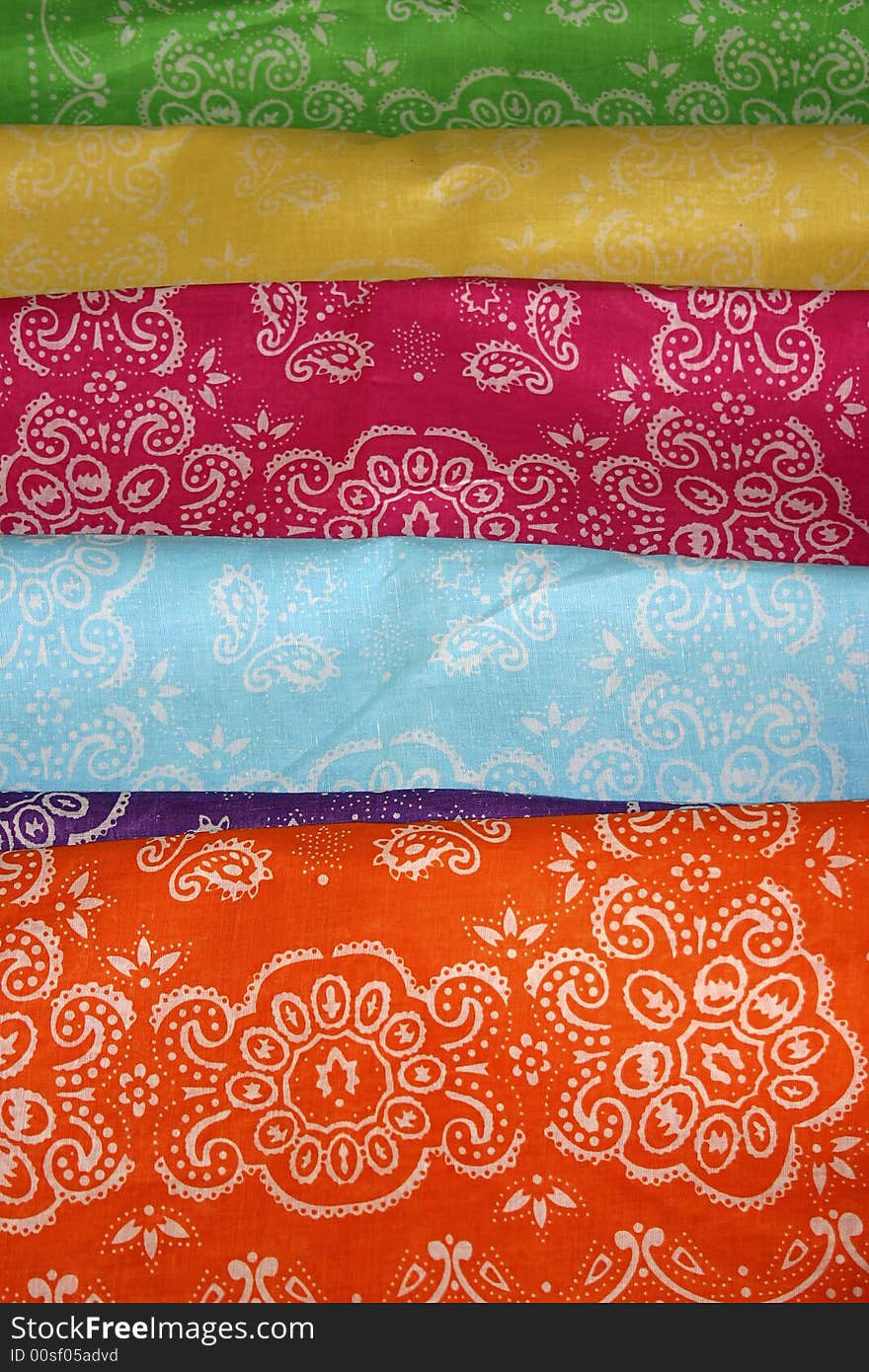 A collection of colorful, patterned  cloth bandanas.