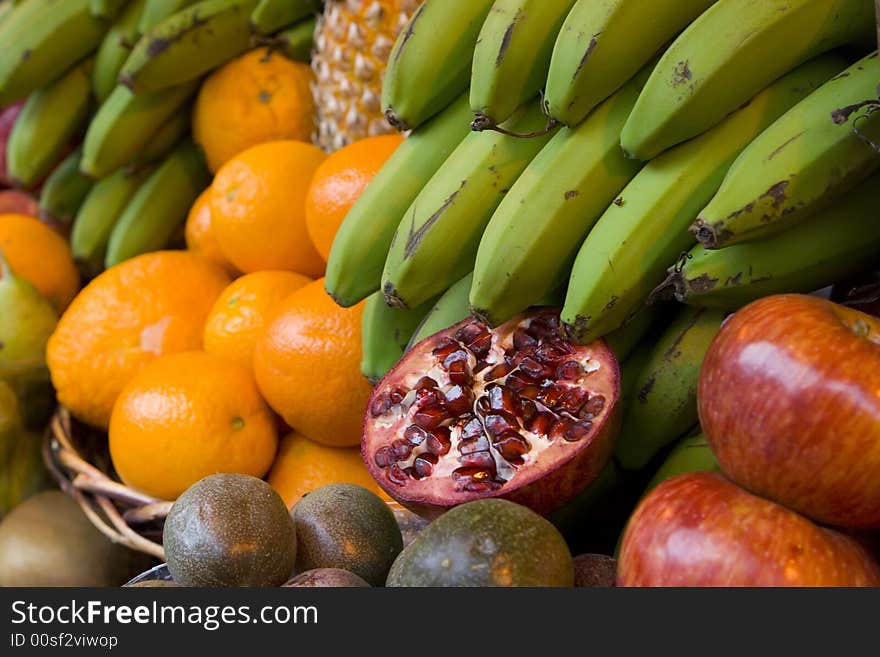 Tropica fruits: pomegranate, bananas oranges.