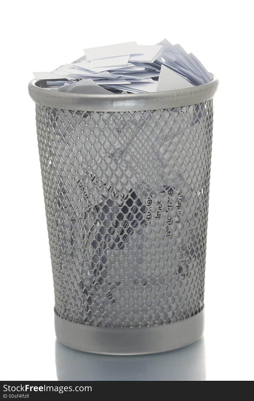 Mesh trash bin full of paper