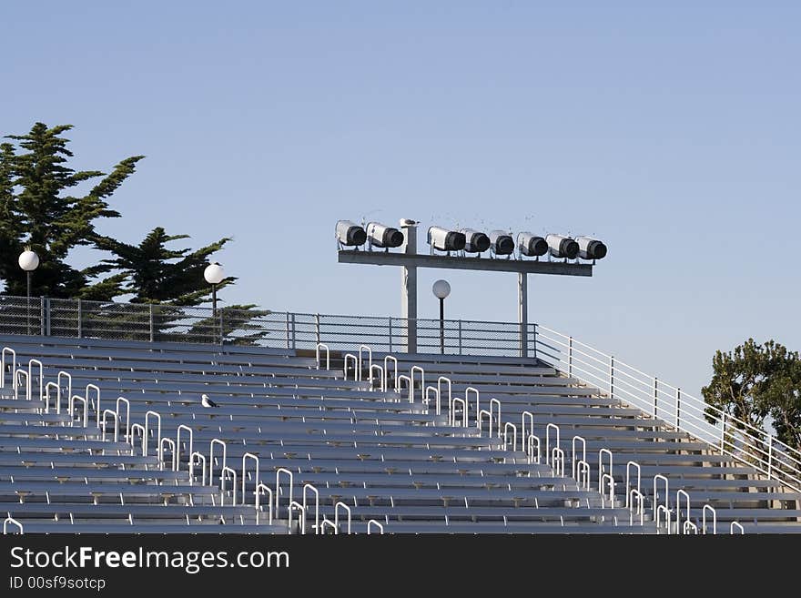 Empty seats for a show with the spotlights and trees in the background... Warm sunny winter day. Empty seats for a show with the spotlights and trees in the background... Warm sunny winter day...