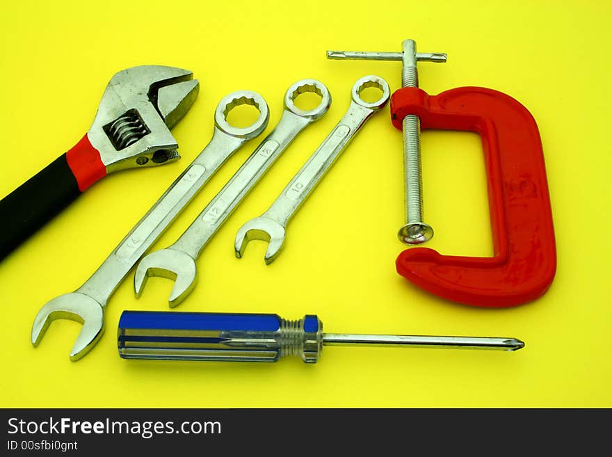 Several tools over a yellow surface