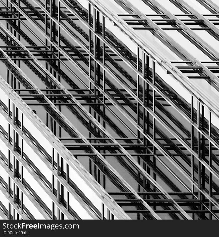 Square format, diagonal composition, black and white photo abstract of ornamental lattice on the exterior curtain wall of an office building. Square format, diagonal composition, black and white photo abstract of ornamental lattice on the exterior curtain wall of an office building.