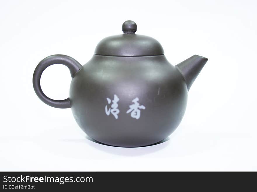 Isolated chinese teapot made of brown clay