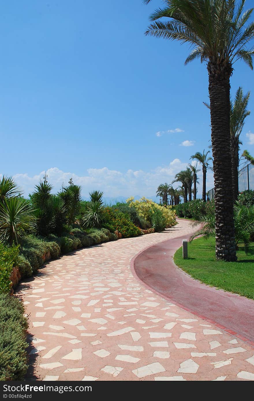 Path in hotel park and blye sky