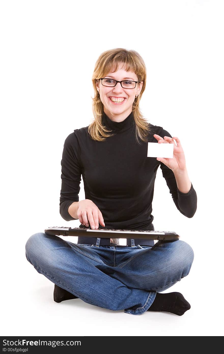 A girl with a keyboard and a card for text in her hand. A girl with a keyboard and a card for text in her hand