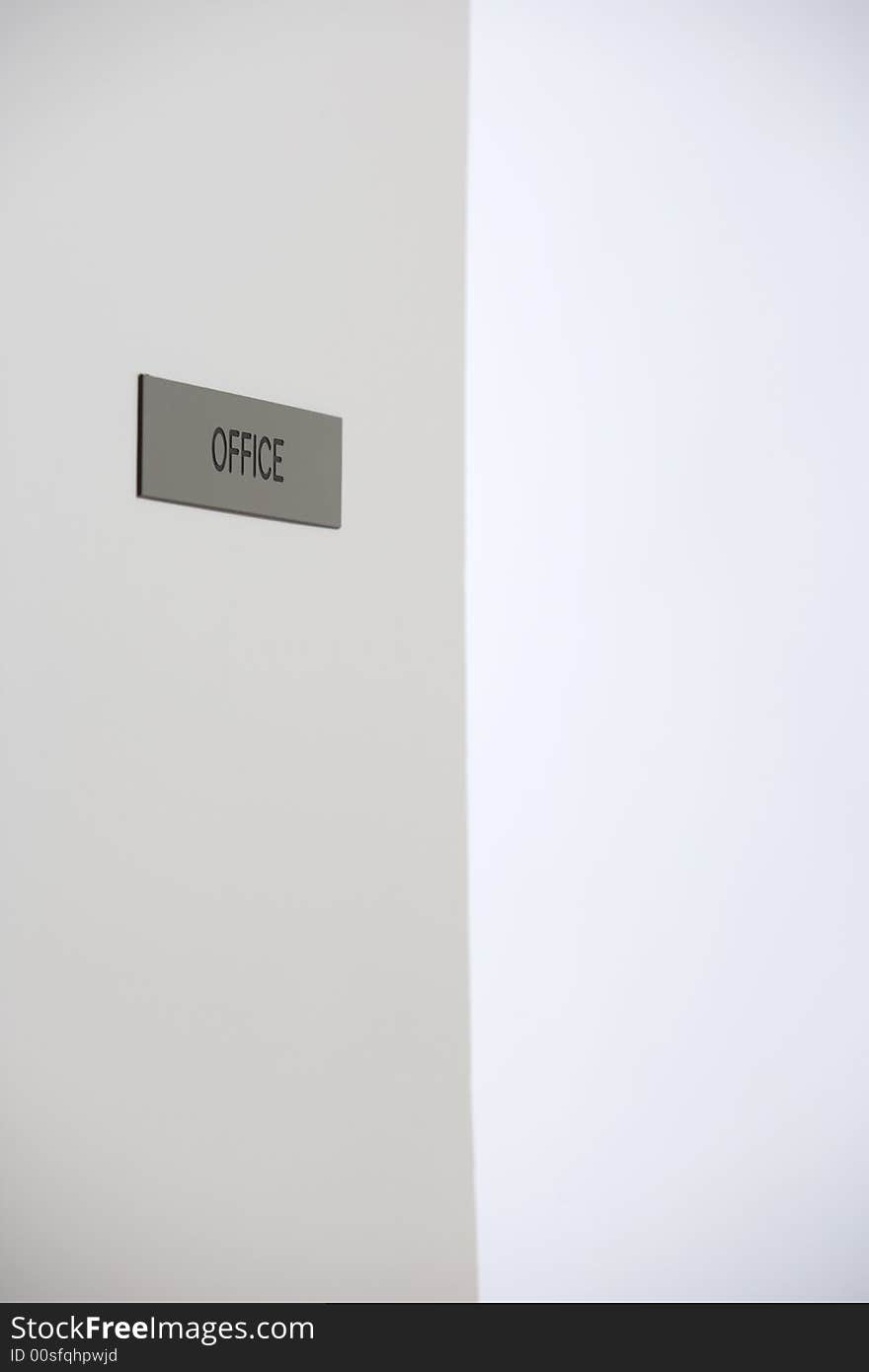 A office sign on a door in a hallway