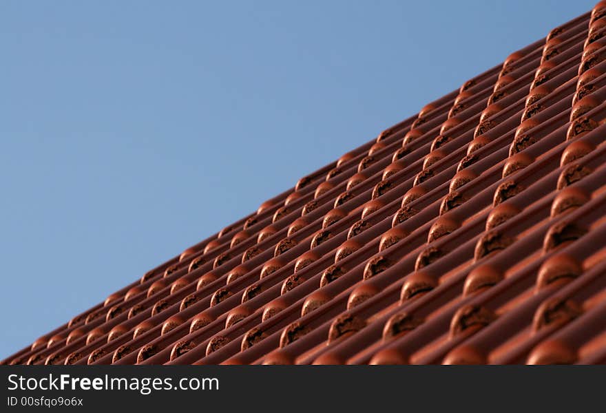 Blue sky and roof tiles in perspective view.