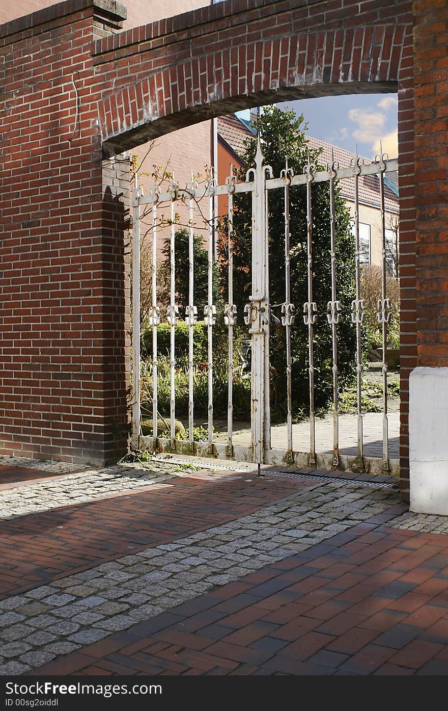 Old gate in a entrance with wall of brick