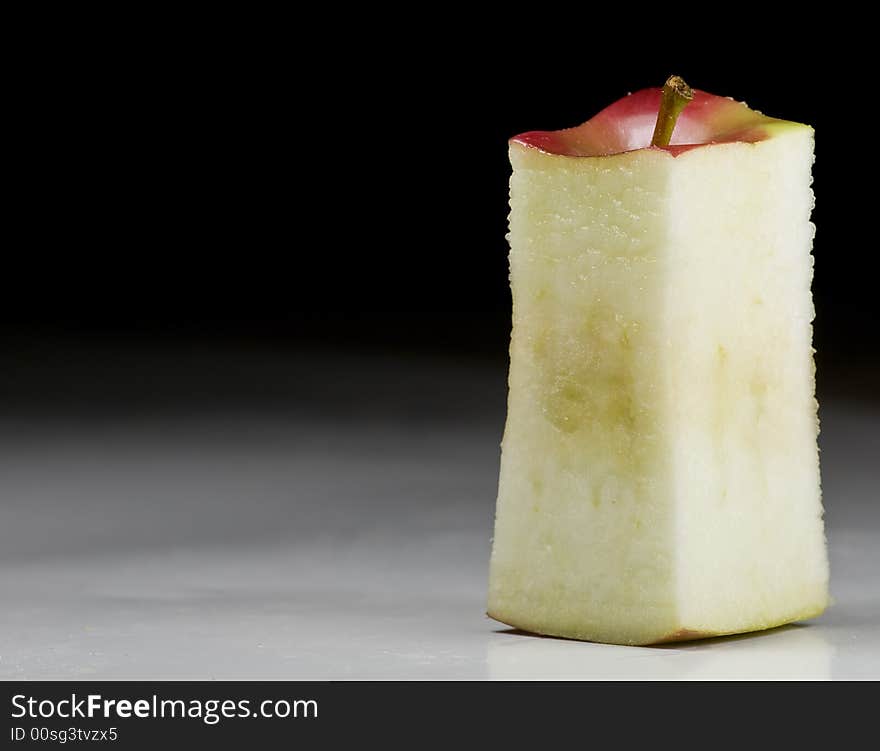 Deliciously juicy cut apple with stem on background. Deliciously juicy cut apple with stem on background