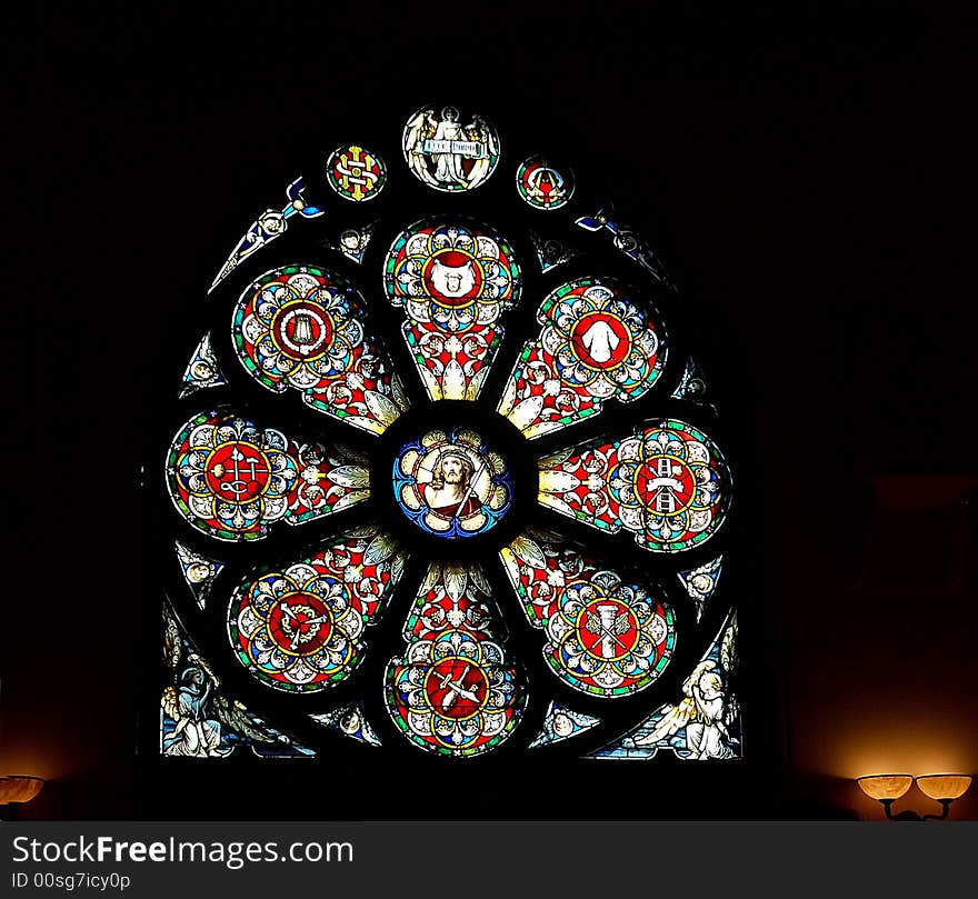 Stained-glass window in church with scene symbol religious