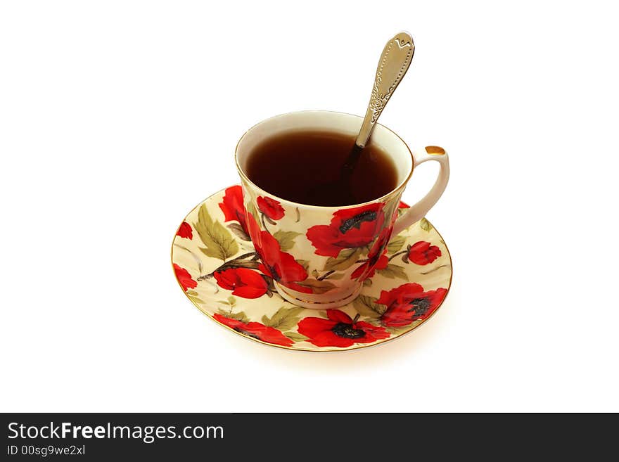 Beautiful cup with tea with a spoon standing on a saucer