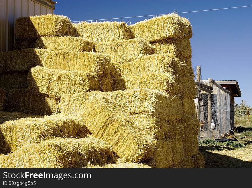 Hay bales stacked in autumn in Galisteo, New Mexcio. This is on the highway from Santa Fe south to I-40. It runs along the east side of the Sandia Mountains and is called the Turquoise Trail. There is a very picturesque  string of small towns along this road. They were settled by the original Hispanic explorers. Hay bales stacked in autumn in Galisteo, New Mexcio. This is on the highway from Santa Fe south to I-40. It runs along the east side of the Sandia Mountains and is called the Turquoise Trail. There is a very picturesque  string of small towns along this road. They were settled by the original Hispanic explorers.