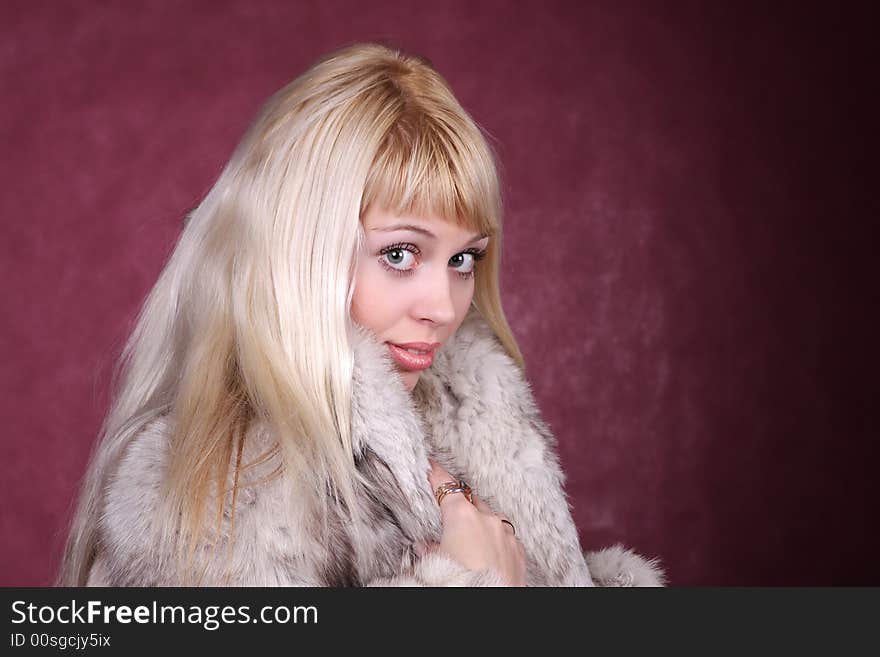 Portrait of the nice girl in fur coat