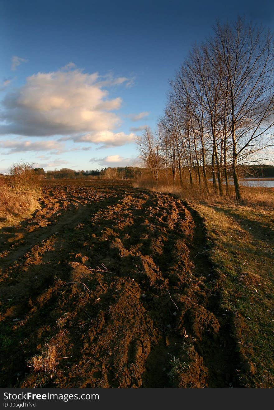 Field about the pond, subsoil ploughing,light leaner,water, pond,cloud drift