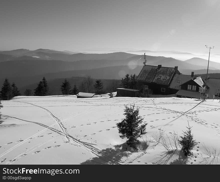 Small hostel in mountains in background big mountain. Winter Time. Small hostel in mountains in background big mountain. Winter Time