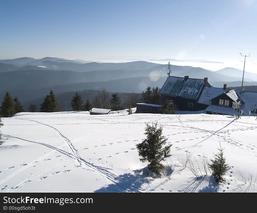 Small hostel in mountains in background big mountain. Winter Time. Small hostel in mountains in background big mountain. Winter Time