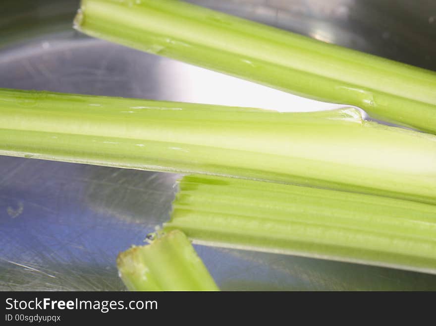 Green Celery floating around in a pot with water. Green Celery floating around in a pot with water.