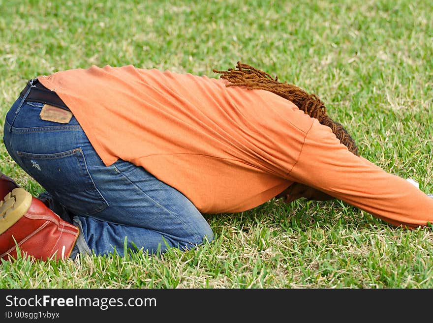 Man doing yoga on the green grass. Man doing yoga on the green grass