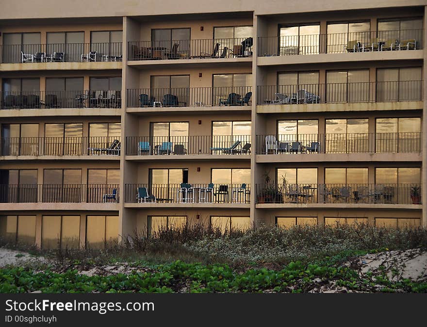 Condominium windows reflect the sunrise on the beach at South Padre Island, Texas. Condominium windows reflect the sunrise on the beach at South Padre Island, Texas.