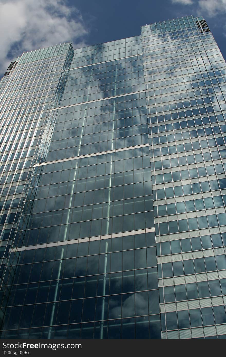 Clouds Reflecting On Side Of Glass Building