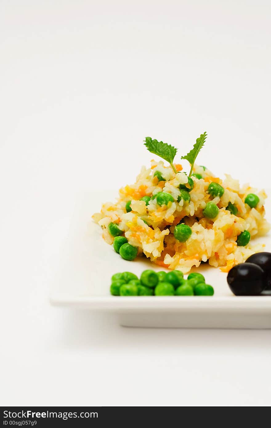 Pilau with vegetables. Isolated on white.