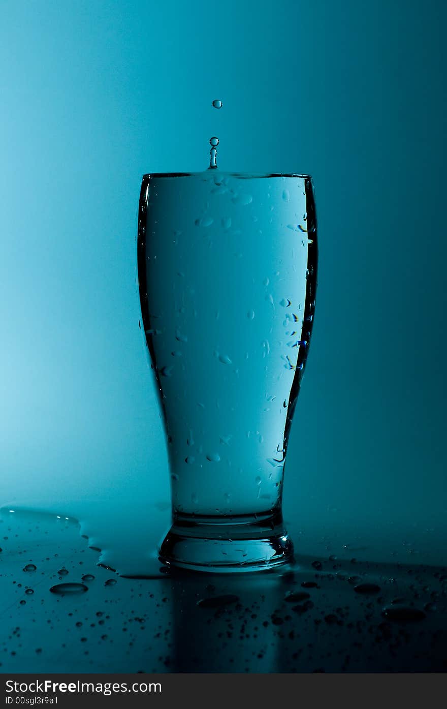 Glass of pure water in a blue tone. Glass of pure water in a blue tone