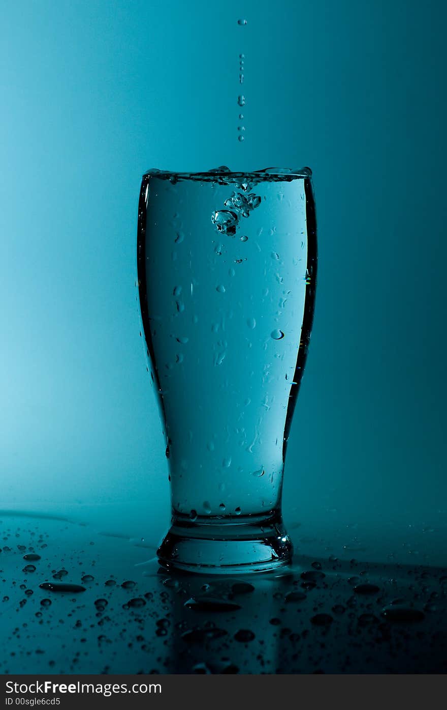 Glass of pure water in a blue tone. Glass of pure water in a blue tone