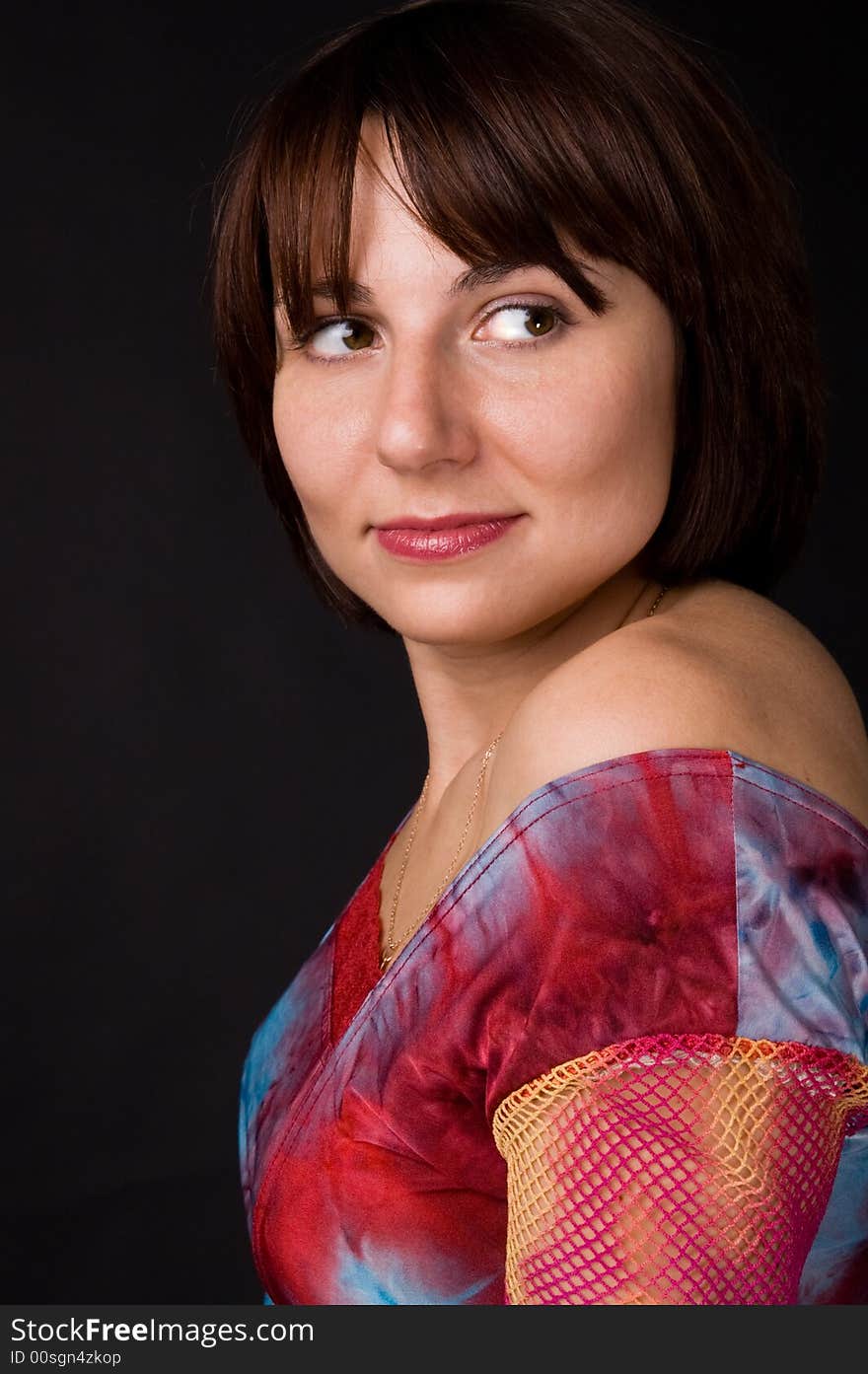 The woman in a bright dress on a black background