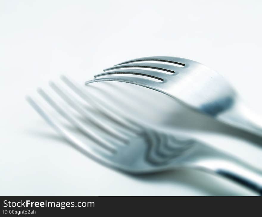 Two forks on a white background