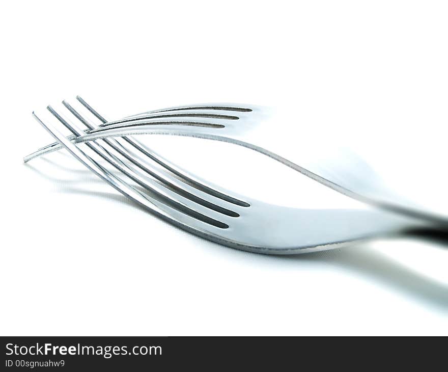 Two forks on a white background