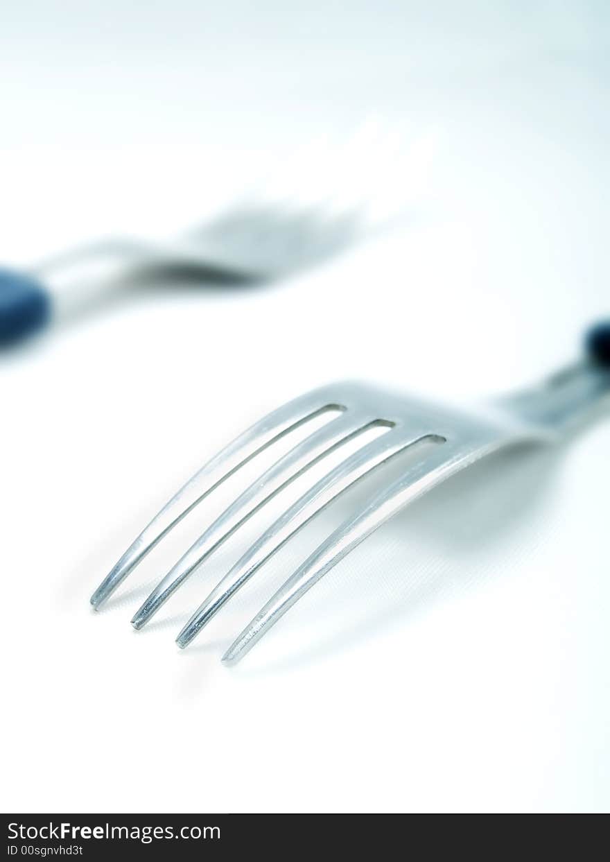 Two forks on a white background