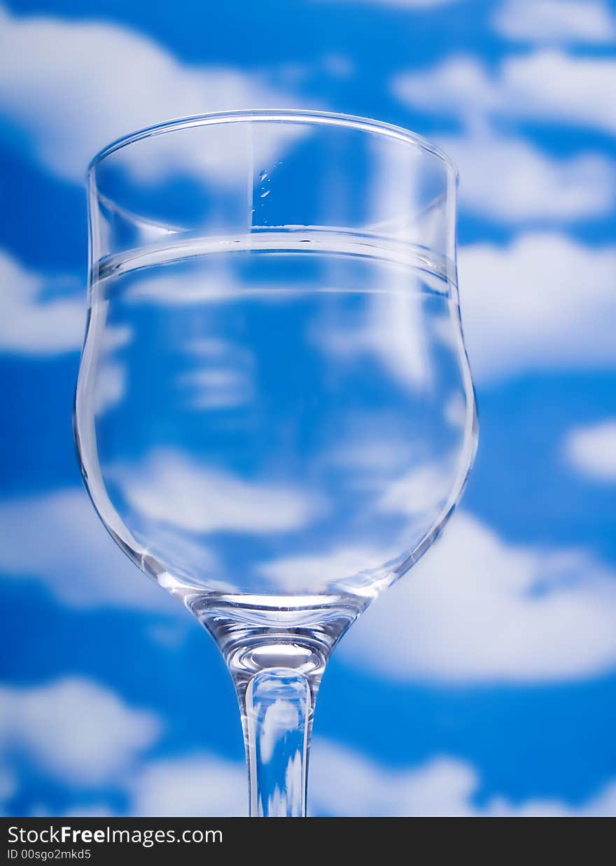 Glass of water over a blue sky