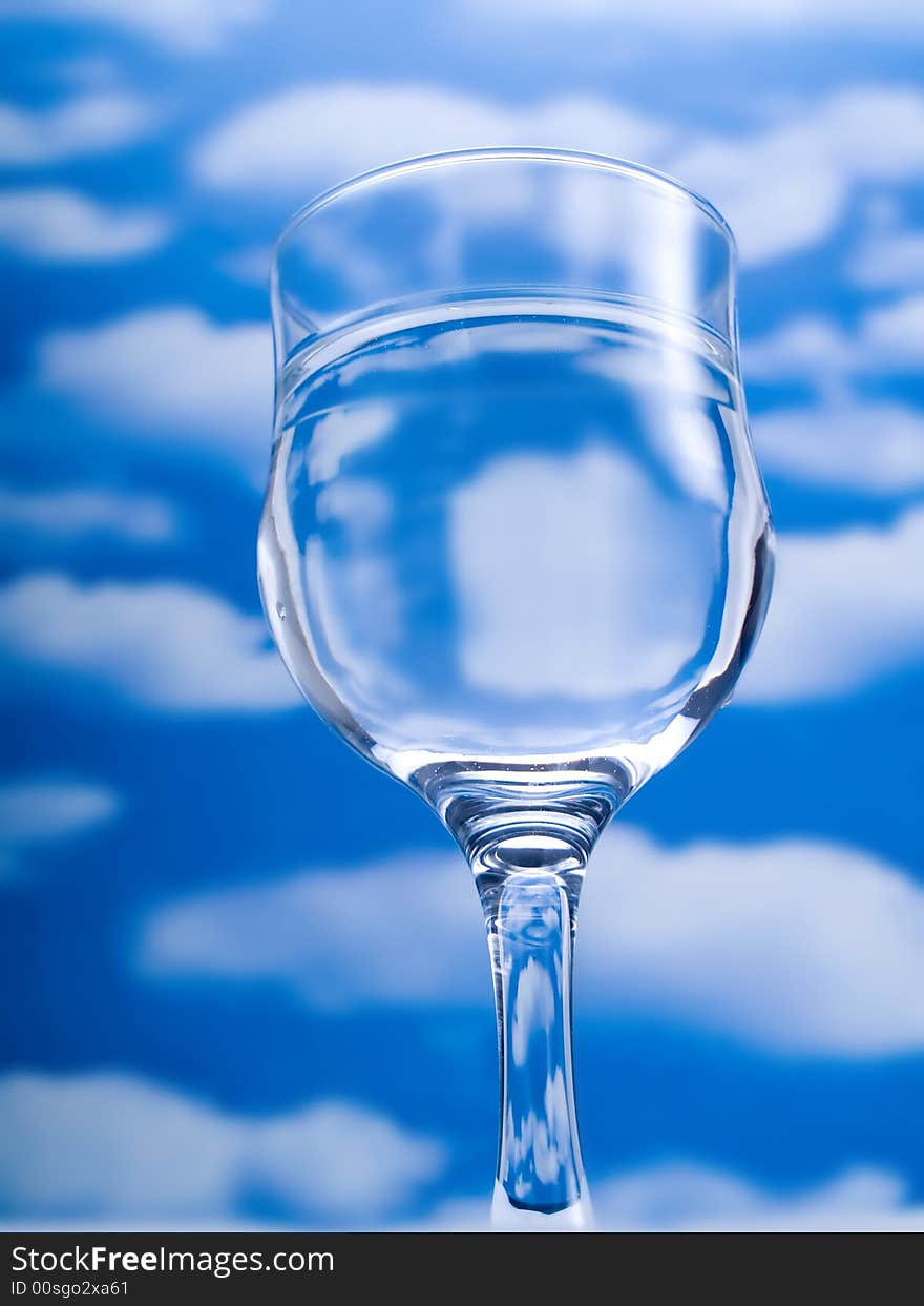 Glass of water over a blue sky