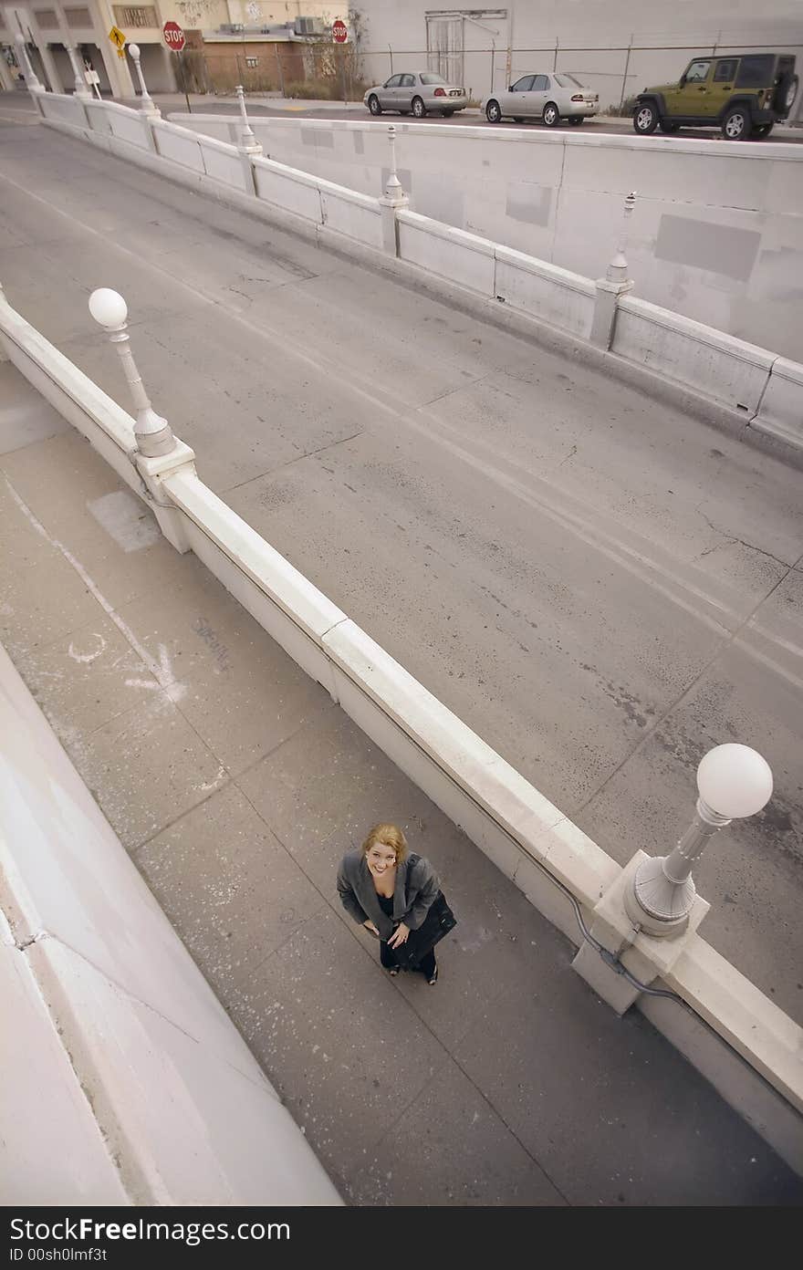 Wide shot from above of woman on a sidewalk. Wide shot from above of woman on a sidewalk